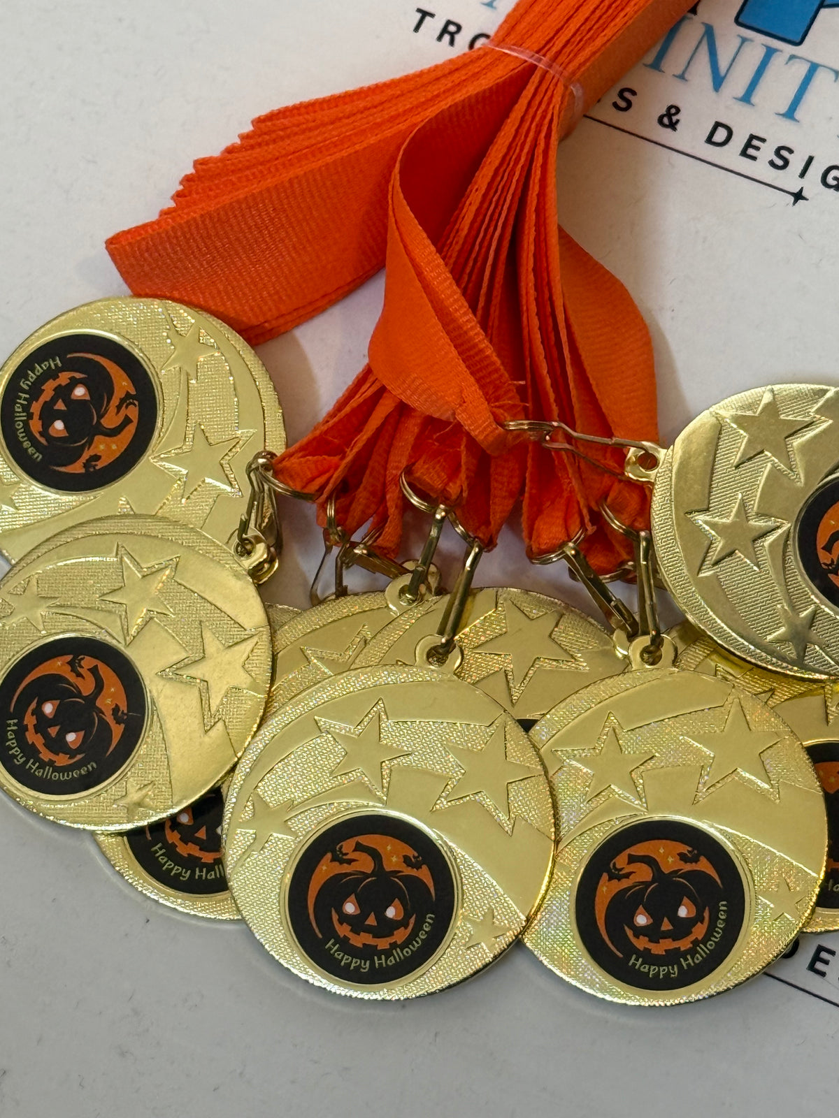Halloween pumpkin medals with star detailing and orange ribbons